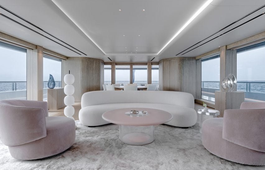 The main bedroom suite includes a blue chrome and resin coffee table next to a curved sofa.